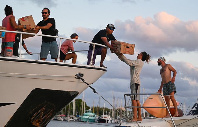 Volunteers from France, Germany and Italy prepare boats in Isla Mujeres for a humanitarian voyage to Havana, Cuba.