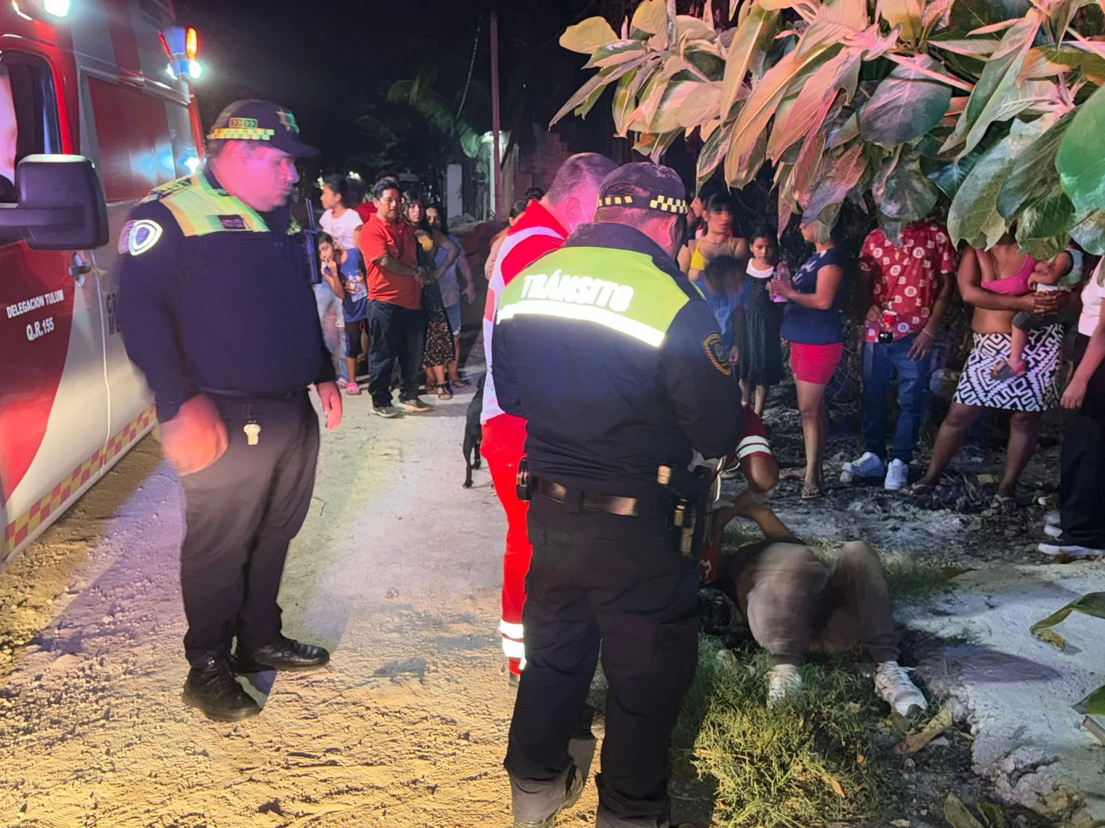 A woman lying on the ground after a motorcycle incident in Tulum's Carlos Joaquin neighborhood