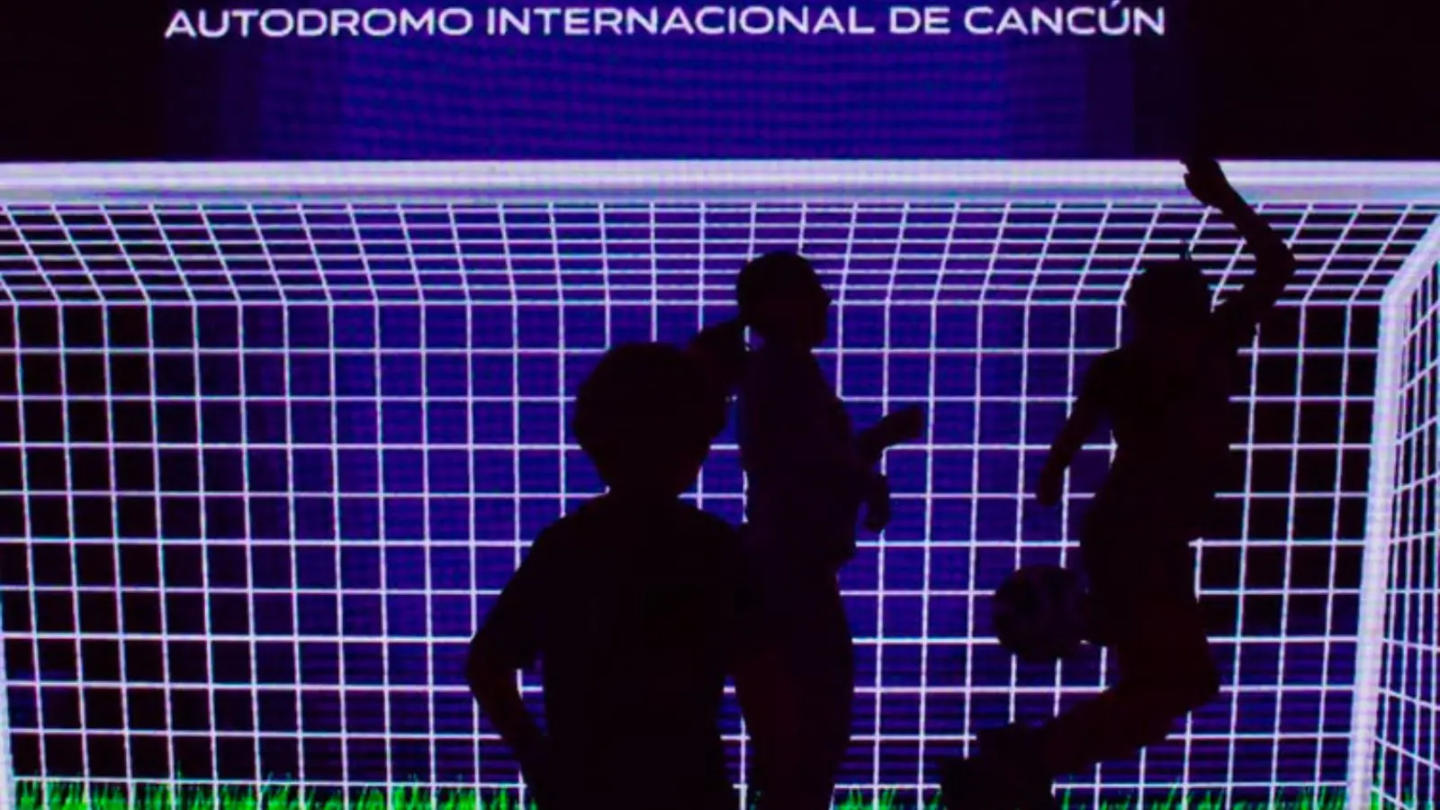 Dozens of soccer fans watch the World Cup 2026 opening match on giant LED screens at the Paddock Club in Cancun's Autodromo Internacional.
