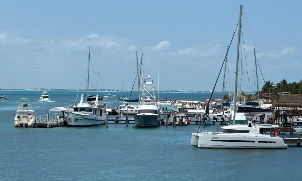 A yacht anchored in turquoise waters near a mangrove reserve in Quintana Roo