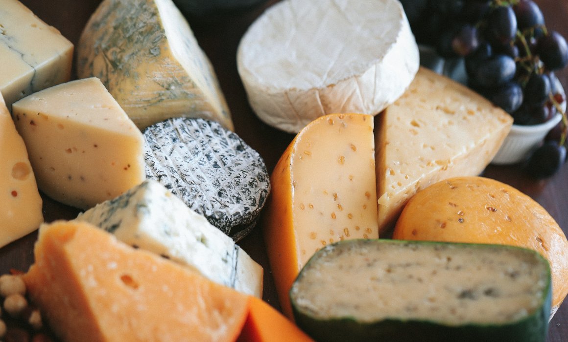 A variety of Mexican artisan cheeses displayed on a wooden board