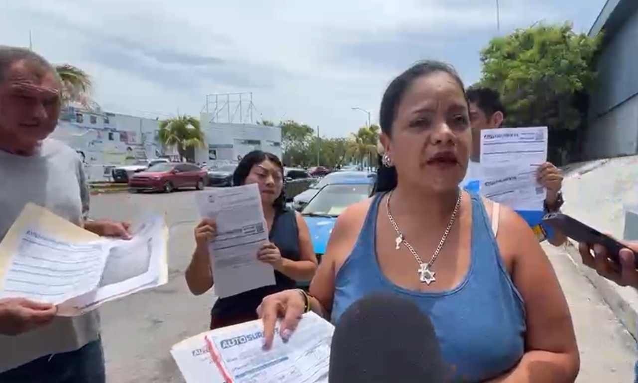 Victims of Autosureste fraud gather outside the State Prosecutor's Office in Cancun to file complaints.