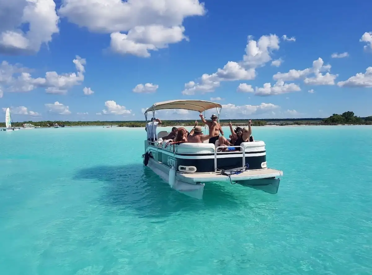 Tourists wearing life jackets on a boat in Bacalar lagoon
