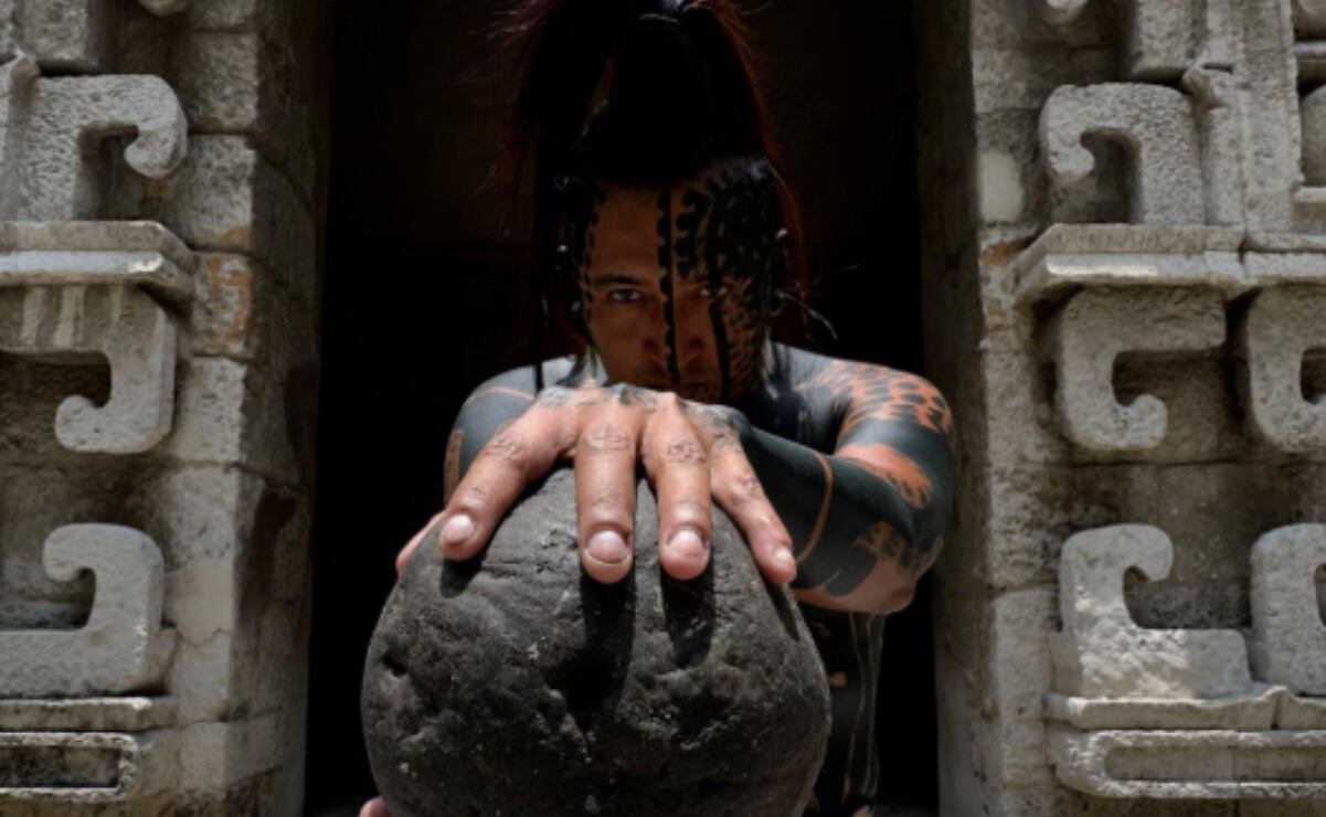 Balam, the Maya influencer, holding a traditional rubber ball at the National Museum of Anthropology in Mexico City