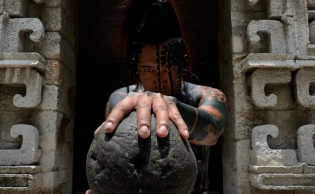 Balam, the Maya influencer, holding a traditional rubber ball at the National Museum of Anthropology in Mexico City