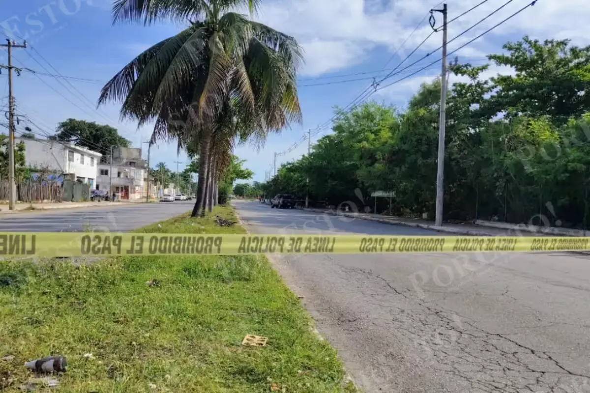 Forensic investigators at the scene where a body was found wrapped in a sheet in Cancun