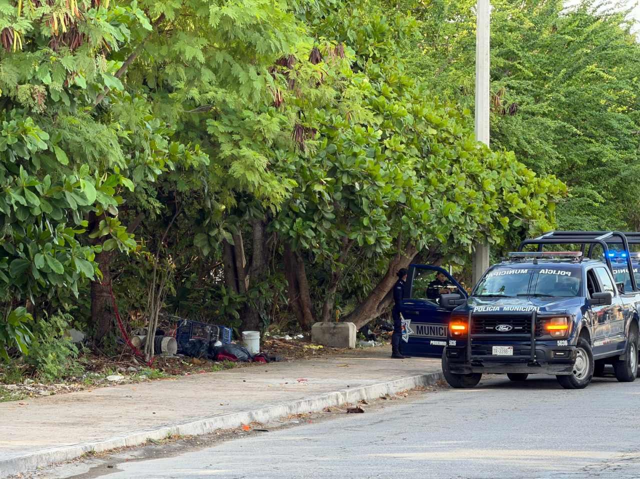 Crime scene tape cordoning off area where a body wrapped in blankets was found near the Candelario Lira sports complex in Cancun