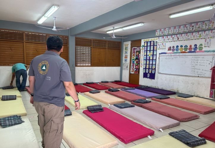 Civil protection officials inspect a hurricane shelter at a Cancun hotel