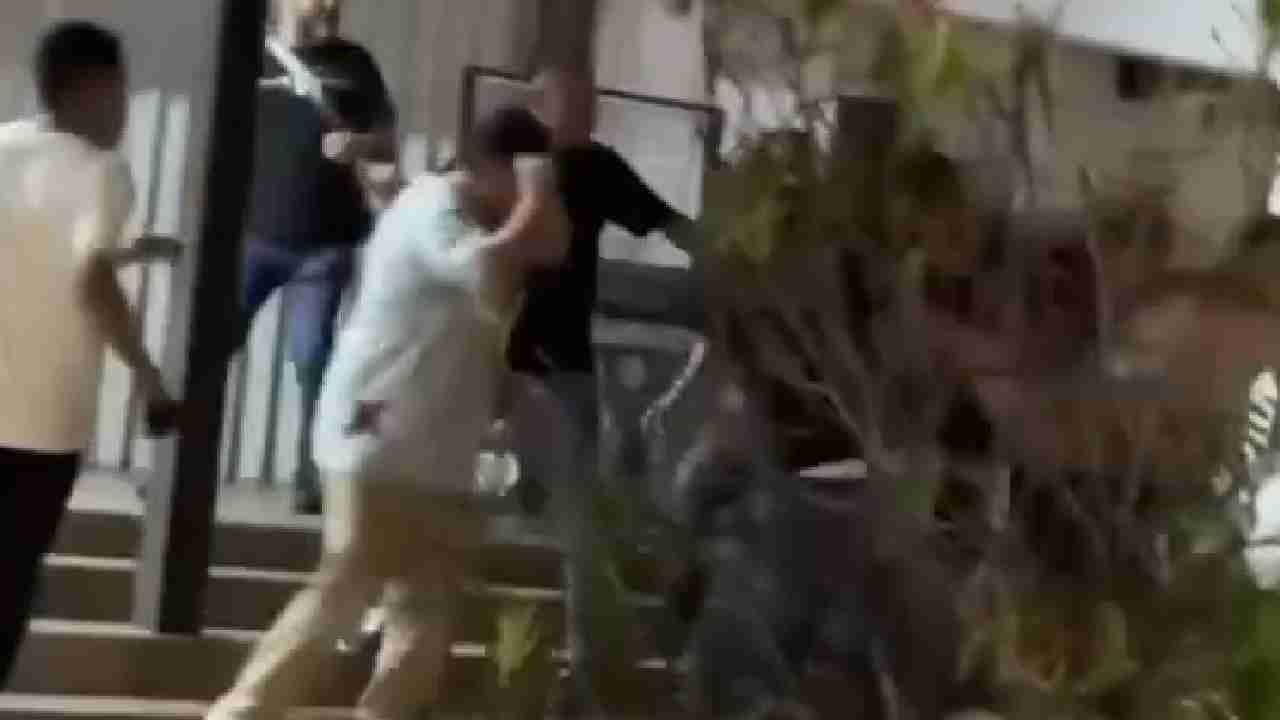 Video screenshot shows a brawl between tourists in Cancun's hotel zone, with onlookers watching.