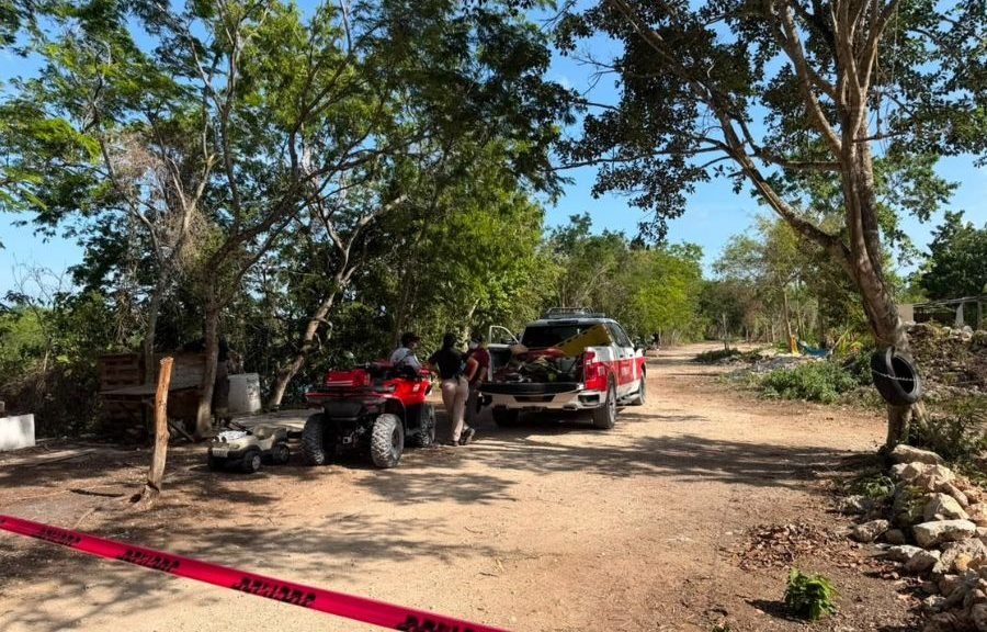 Emergency personnel at a lagoon in Cancun's Santa Cecilia neighborhood recovering a body