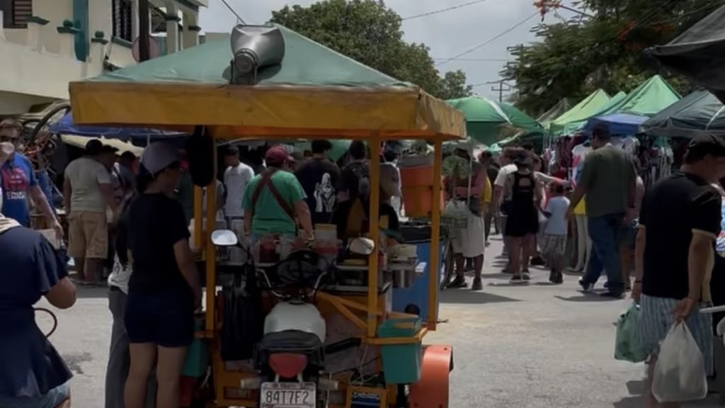 People browsing stalls at a Cancun street market during summer vacation