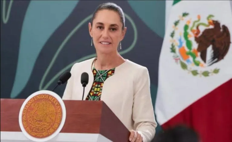 Mexican President Claudia Sheinbaum speaking at a podium during a previous official visit