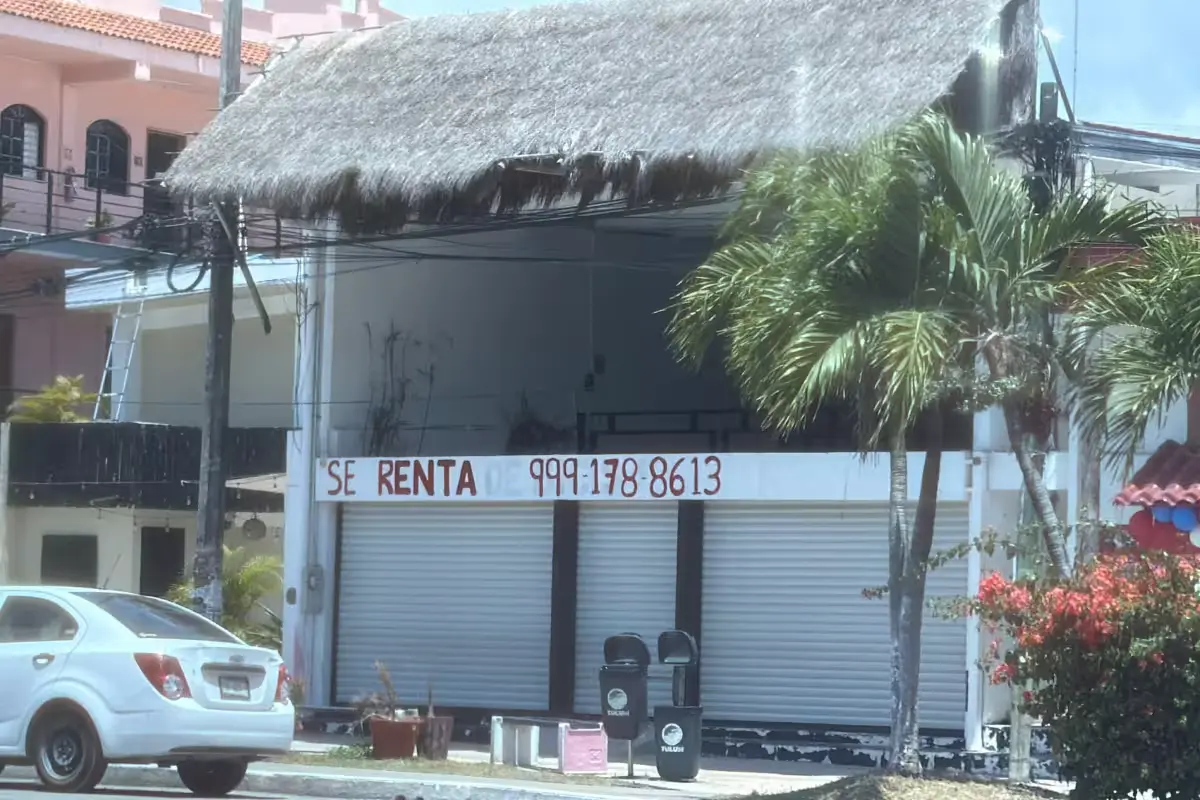 A row of shuttered storefronts in Tulum, Quintana Roo, showing signs of economic downturn