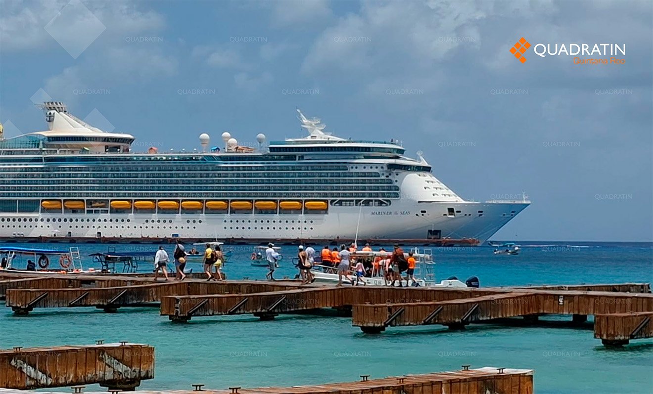 A cruise ship docked at Cozumel with turquoise Caribbean waters in the background