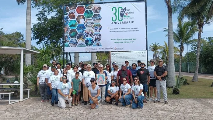 People gather at Cenote Aerolito for the opening event of Cozumel Reefs National Park's 30th anniversary celebrations