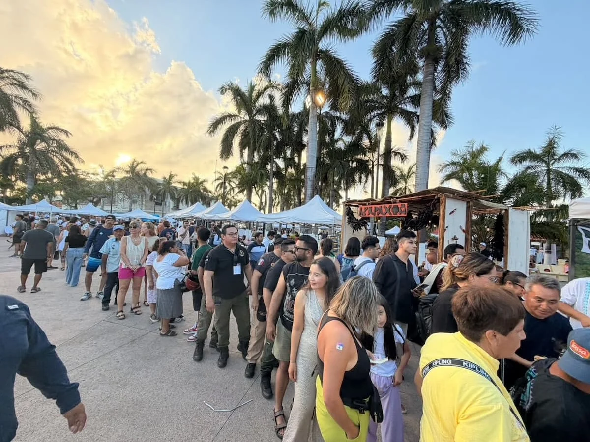 People walking past food stalls at a culinary festival on Quinta Avenida in Playa del Carmen