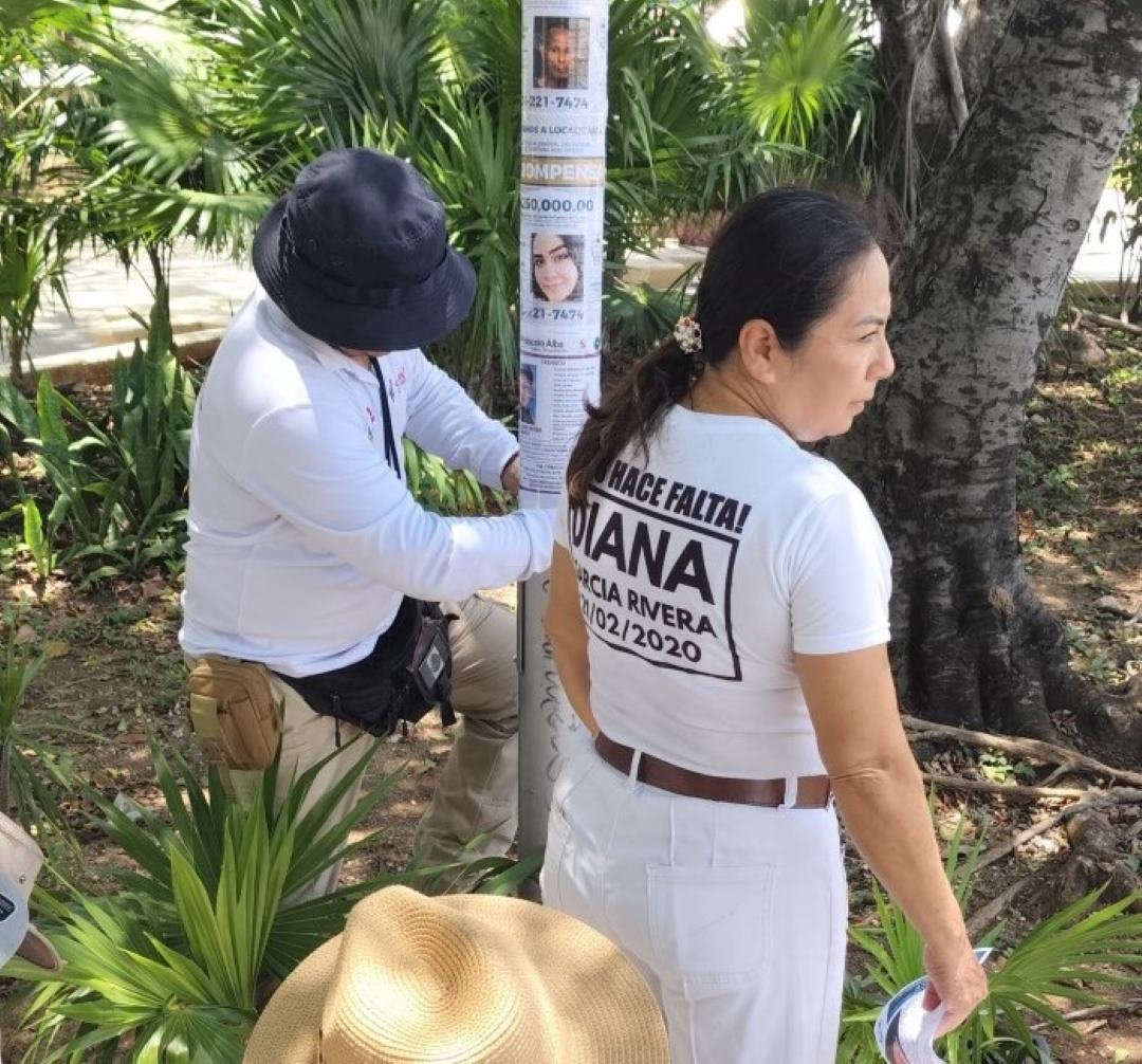A missing person flyer for Diana Garcia posted on a wall in Cancun