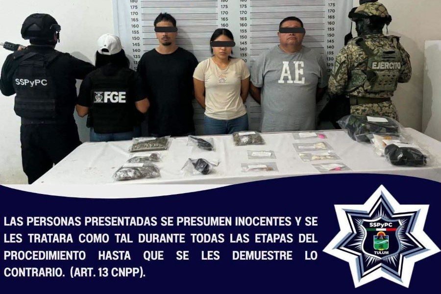 Police officers holding bags of seized drugs and evidence during an operation in Tulum