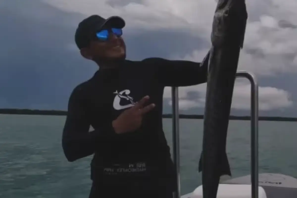 Fishermen inspecting a barracuda catch on a boat in Isla Mujeres, Mexico