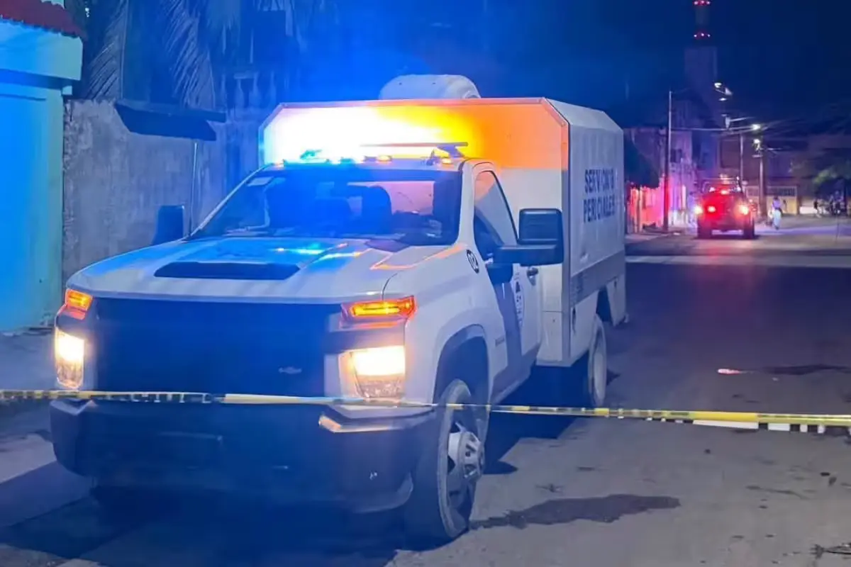 A forensic services vehicle parked at the scene of a shooting in Cancun