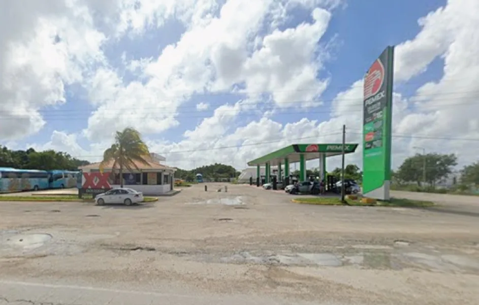 A gas station in Mahahual with a closed sign, fuel pumps idle