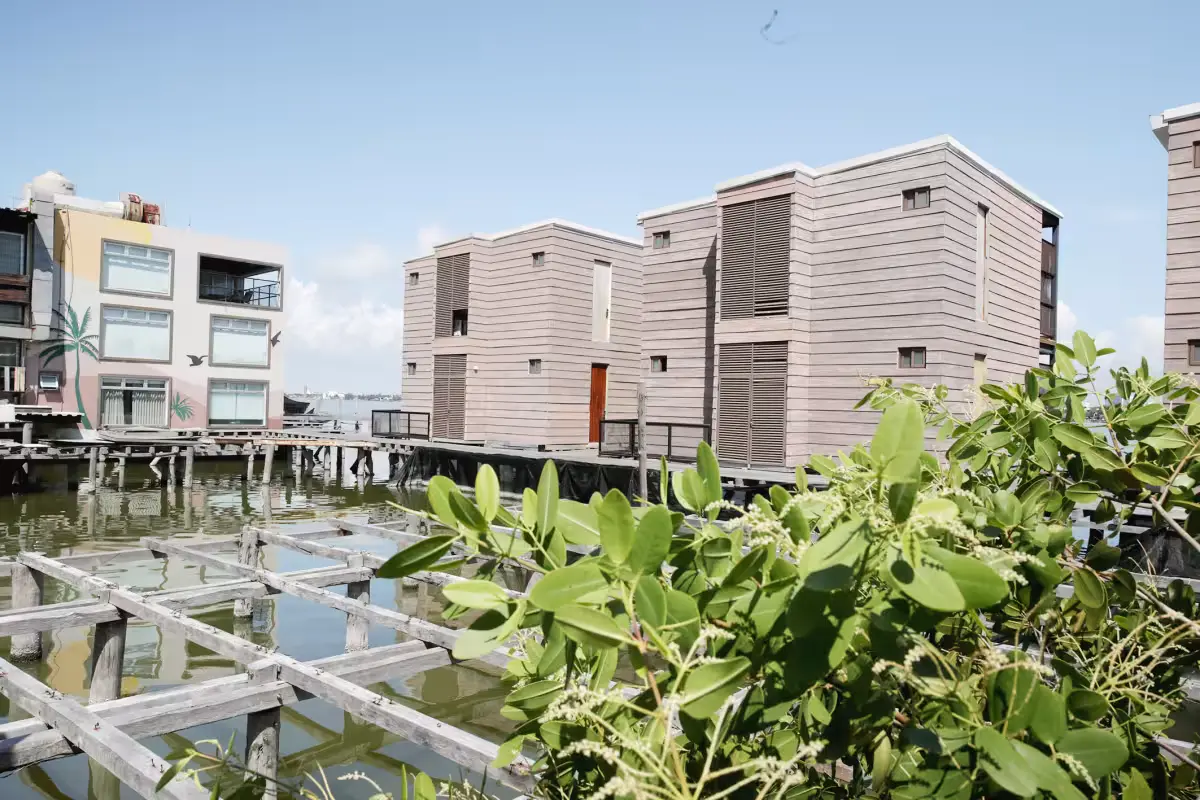 Aerial view of the Mayan Monkey hotel complex built on stilts over Laguna Bojórquez in Cancun's hotel zone, surrounded by mangroves.