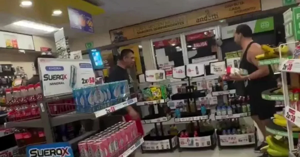 Screenshot from a video showing an LGBT activist being attacked in an Oxxo store in Playa del Carmen