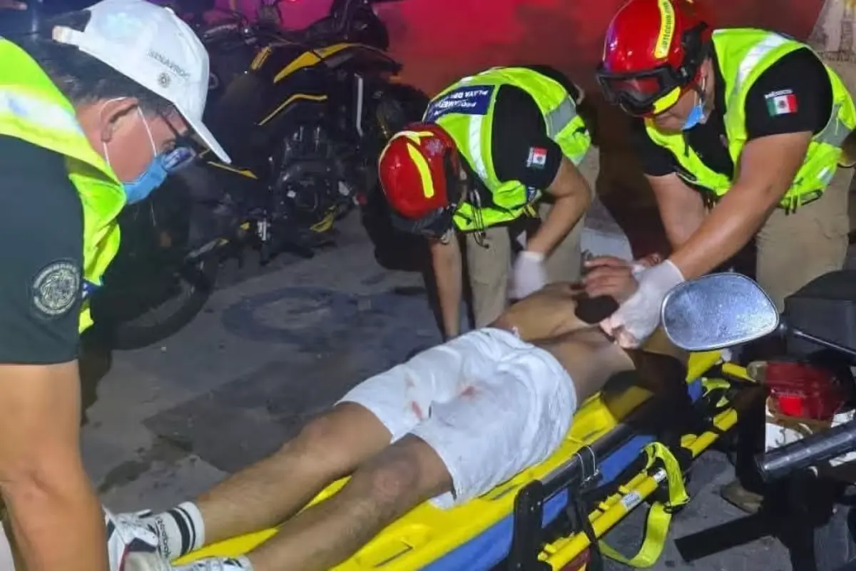 A man lies on the ground after being beaten on Fifth Avenue in Playa del Carmen