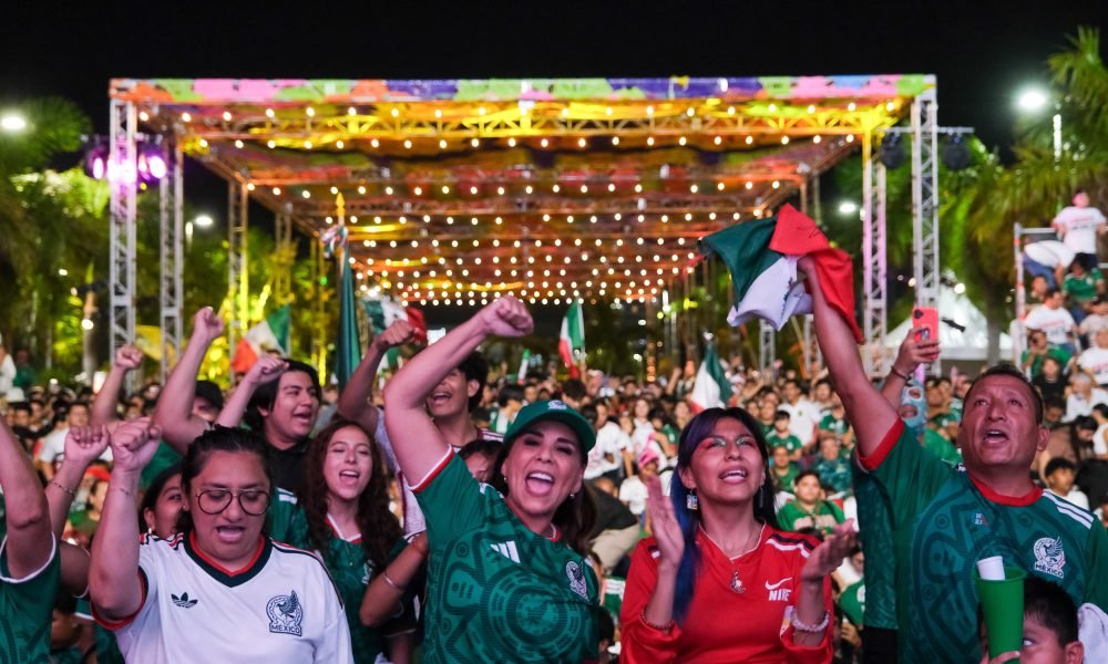 Governor Mara Lezama waving a Mexican flag at a Fut Fest event in Cancun
