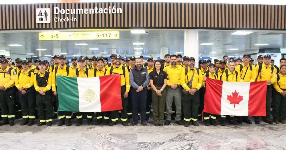 Group of Mexican firefighters in uniform at airport ready to board plane