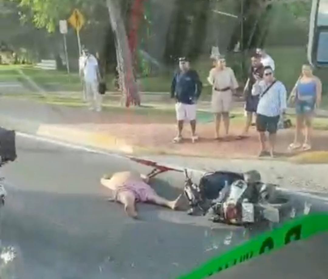 A motorcycle lying on the pavement after a crash in Cancun's hotel zone