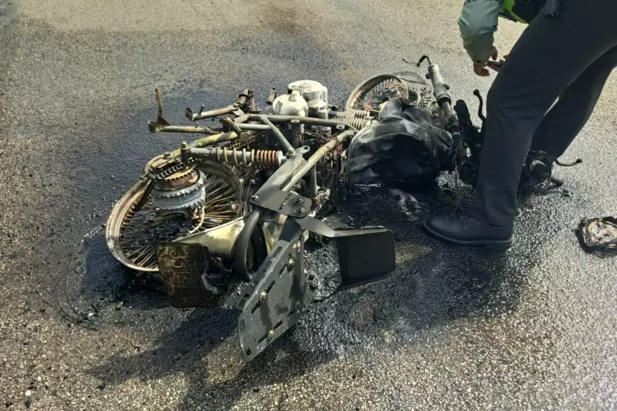 A burned motorcycle on the side of Federal Highway 307 after a collision with a bus