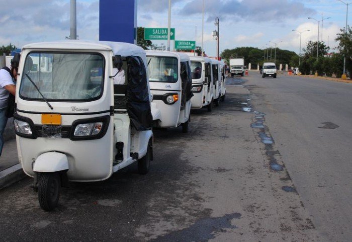 Several mototaxis parked on a street in Playa del Carmen, Mexico