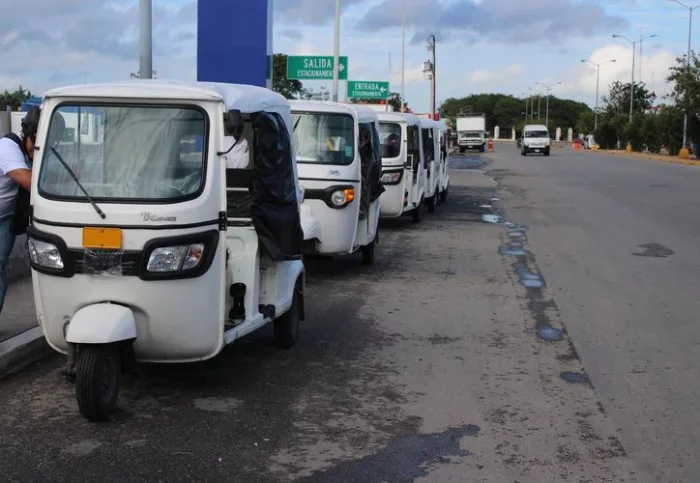Several mototaxis parked on a street in Playa del Carmen, Mexico