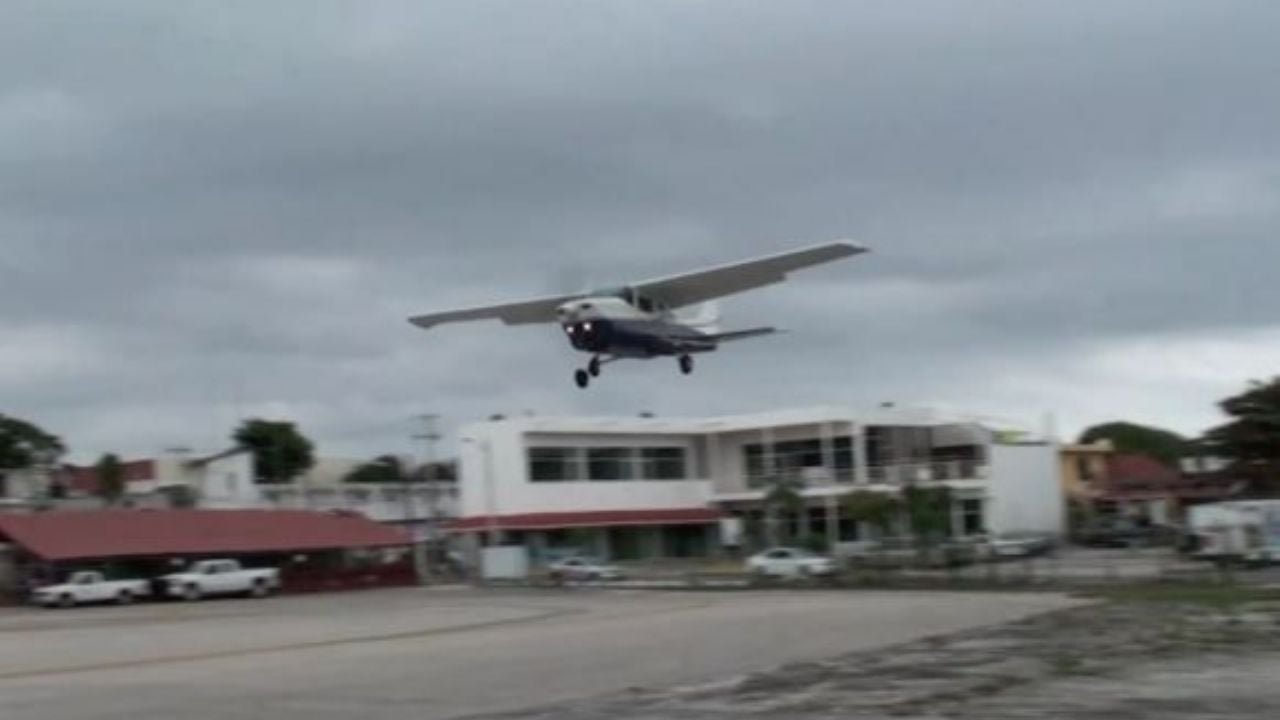 Aerial view of the Playa del Carmen airstrip with small aircraft parked on the tarmac