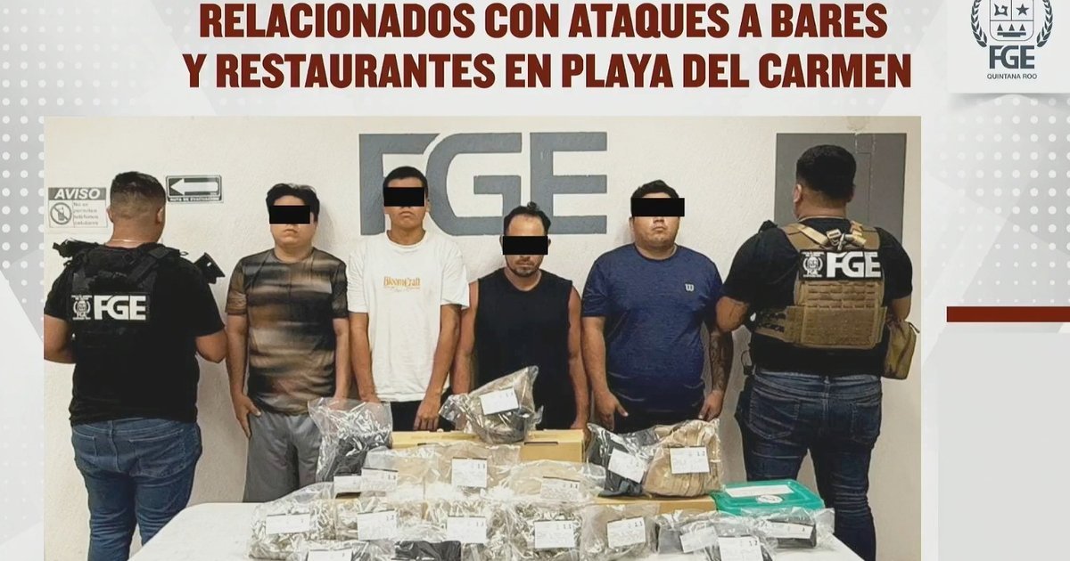Police officers detain suspects during a joint operation in Playa del Carmen