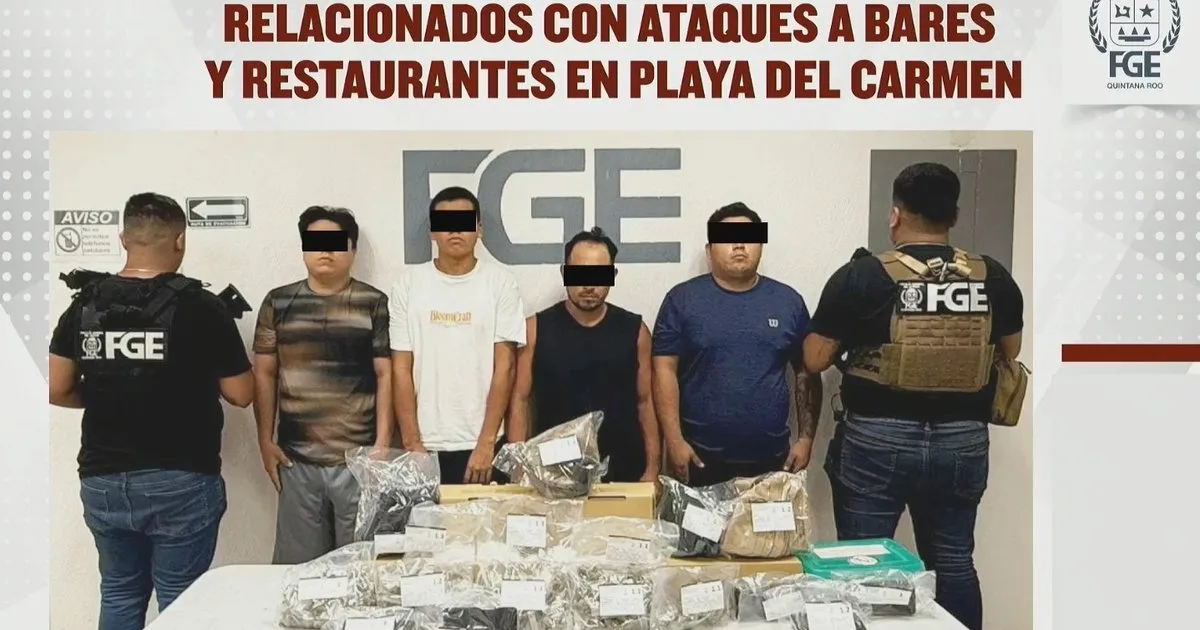 Police officers detain suspects during a joint operation in Playa del Carmen