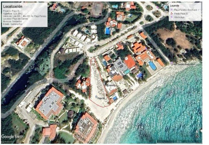 A sandy beach with vegetation and a sign reading Playa Paraiso, the site of the rejected Playa 35 development
