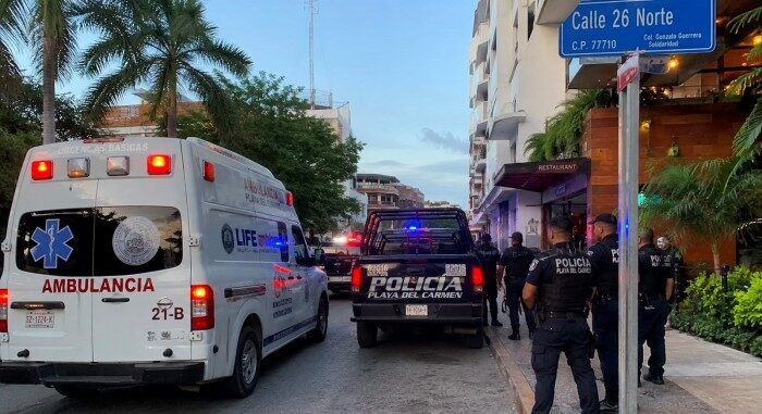 Police officers outside a hotel in Playa del Carmen following a pellet gun attack that injured two tourists