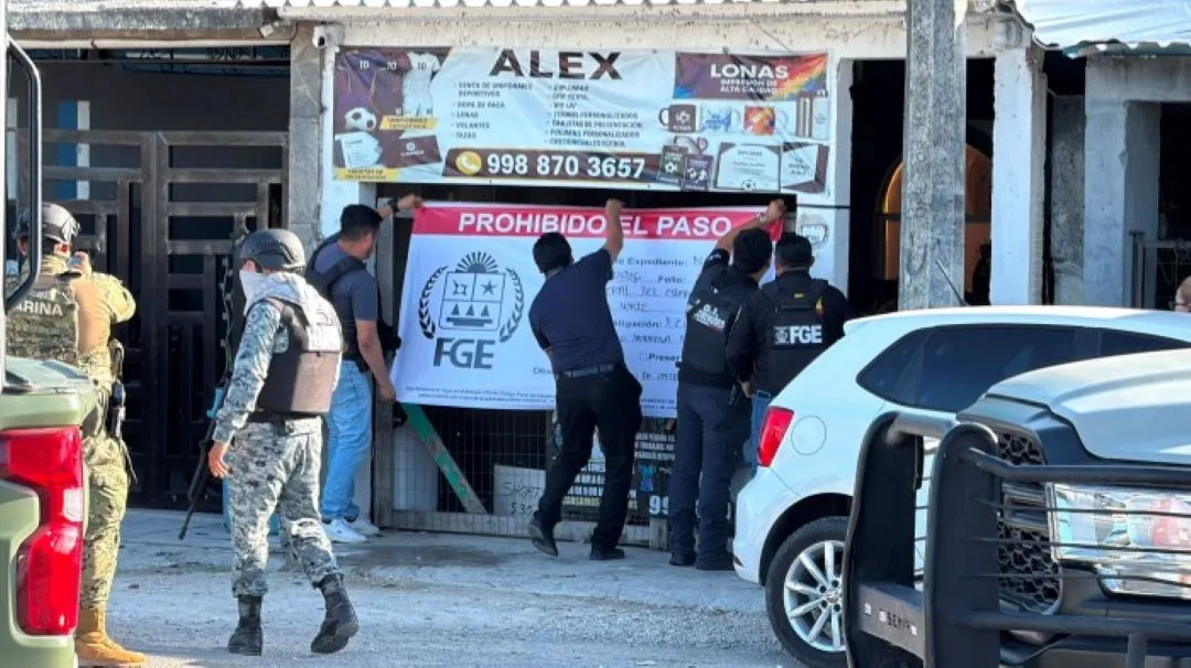 Police officers and military personnel securing a perimeter during a raid in Cancun.