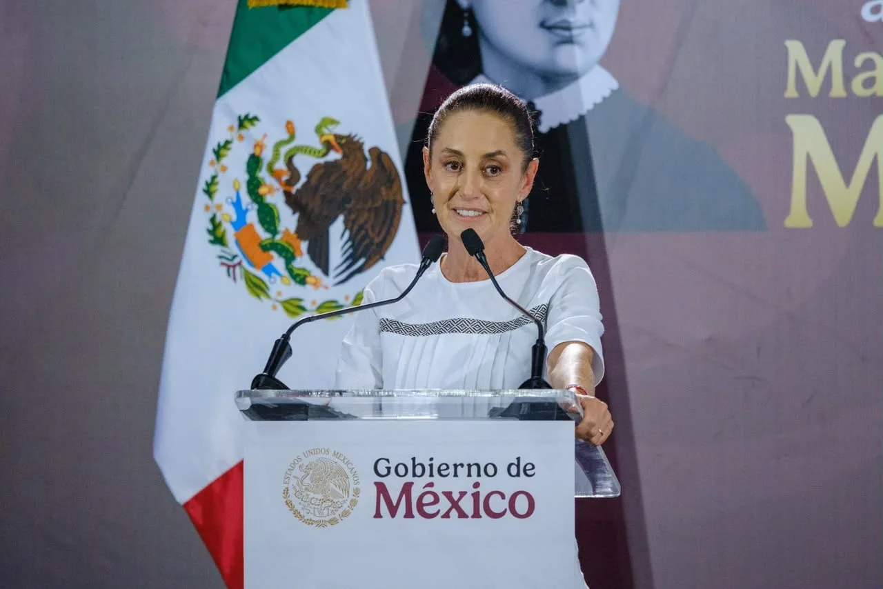 Mexican President Claudia Sheinbaum speaking at a podium during a public event in Quintana Roo
