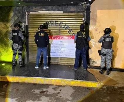 Police officers outside a bar in Othon P. Blanco after a raid rescued 17 women from human trafficking