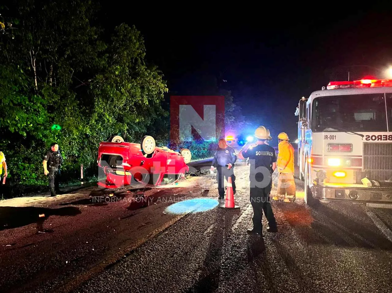 Emergency personnel at the scene of a fatal rollover crash on the bypass road in Felipe Carrillo Puerto
