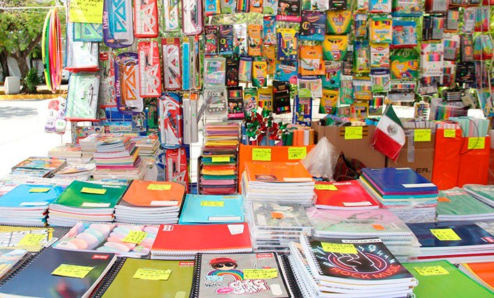 Back to school supplies including notebooks pencils and backpack arranged on a desk