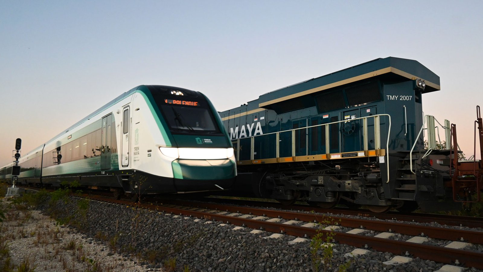 A Maya Train passenger train on tracks in a jungle setting