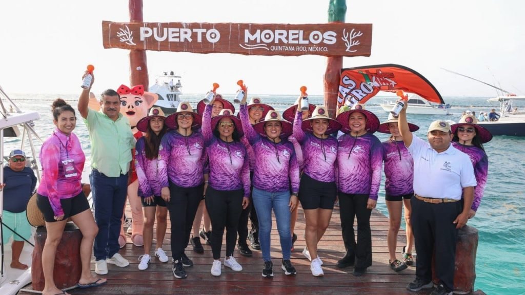 Team Sirenas del Caribe holding trophy at La Diosa del Mar fishing tournament in Puerto Morelos