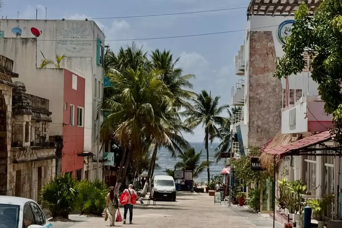 A view of small hotels in Playa del Carmen with few tourists visible