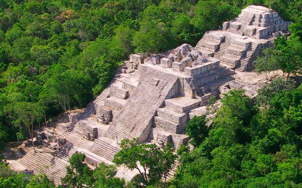 Tourists walking near the ruins of Tulum archaeological site in Quintana Roo, Mexico