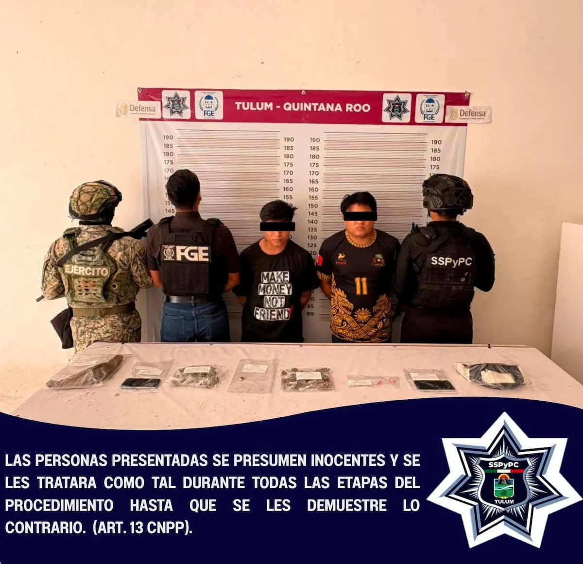 Police officers stand next to seized drugs during an operation in Tulum