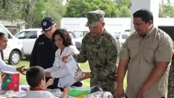 People at a voluntary disarmament fair exchanging toy weapons for educational toys in Quintana Roo
